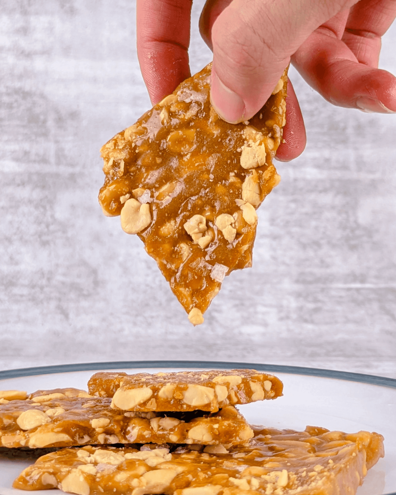 ```
Bob's Brittle peanut brittle hand picked up showing golden butter toffee caramel and roasted peanuts Blue Mountains Australia